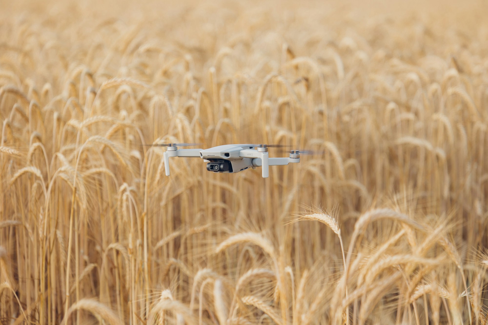 Drone conducting an aerial survey over a field